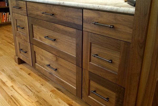 Second kitchen island with walnut drawers and a light granite top in a Bridle Trails kitchen remodel