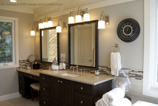 Espresso double vanity with a makeup station, framed mirrors and sconces in a Sammamish primary bathroom