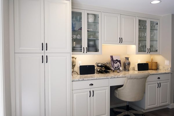 Built-in desk with white painted cabinetry and a stone countertop in a Seattle kitchen remodel