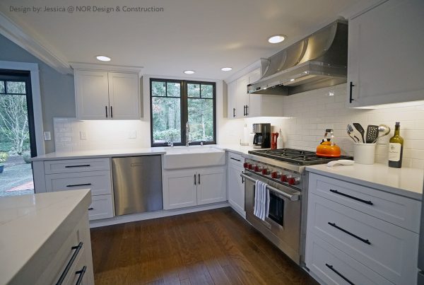 Stainless range and hood, white shaker cabinets and black-framed windows in a Woodinville kitchen remodel