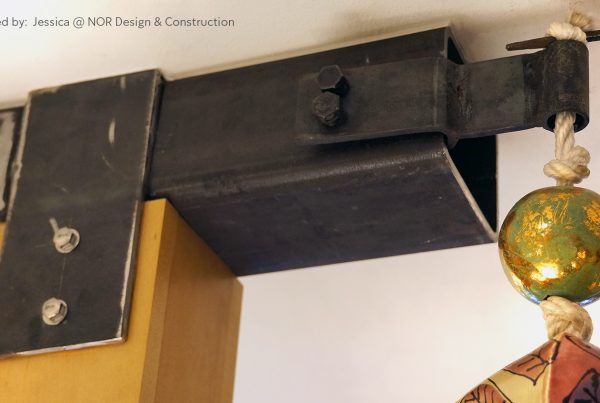 Black steel bracket detail on an exposed wood beam in a Seattle kitchen remodel