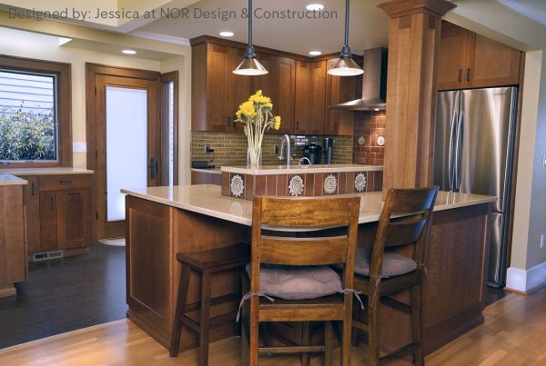 Cherry kitchen with a two-level island, bar stools and pendant lights in a West Seattle kitchen remodel