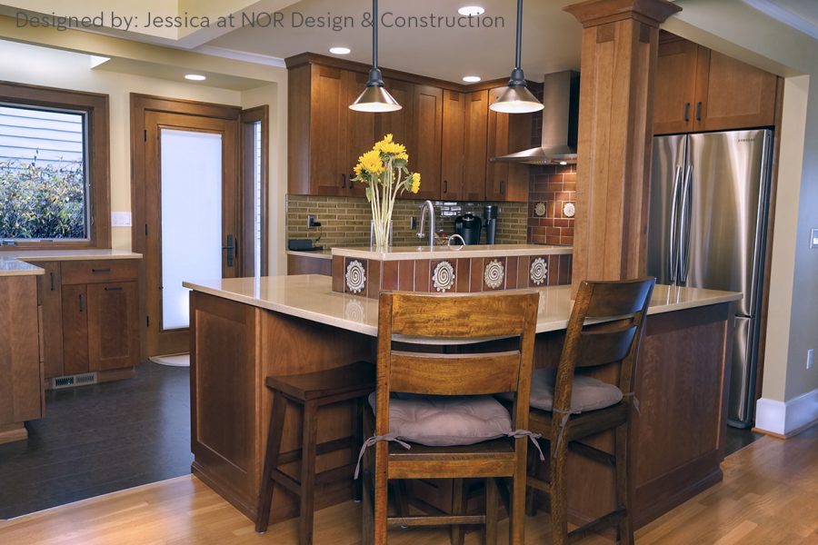 Cherry kitchen with a two-level island, bar stools and pendant lights in a West Seattle kitchen remodel